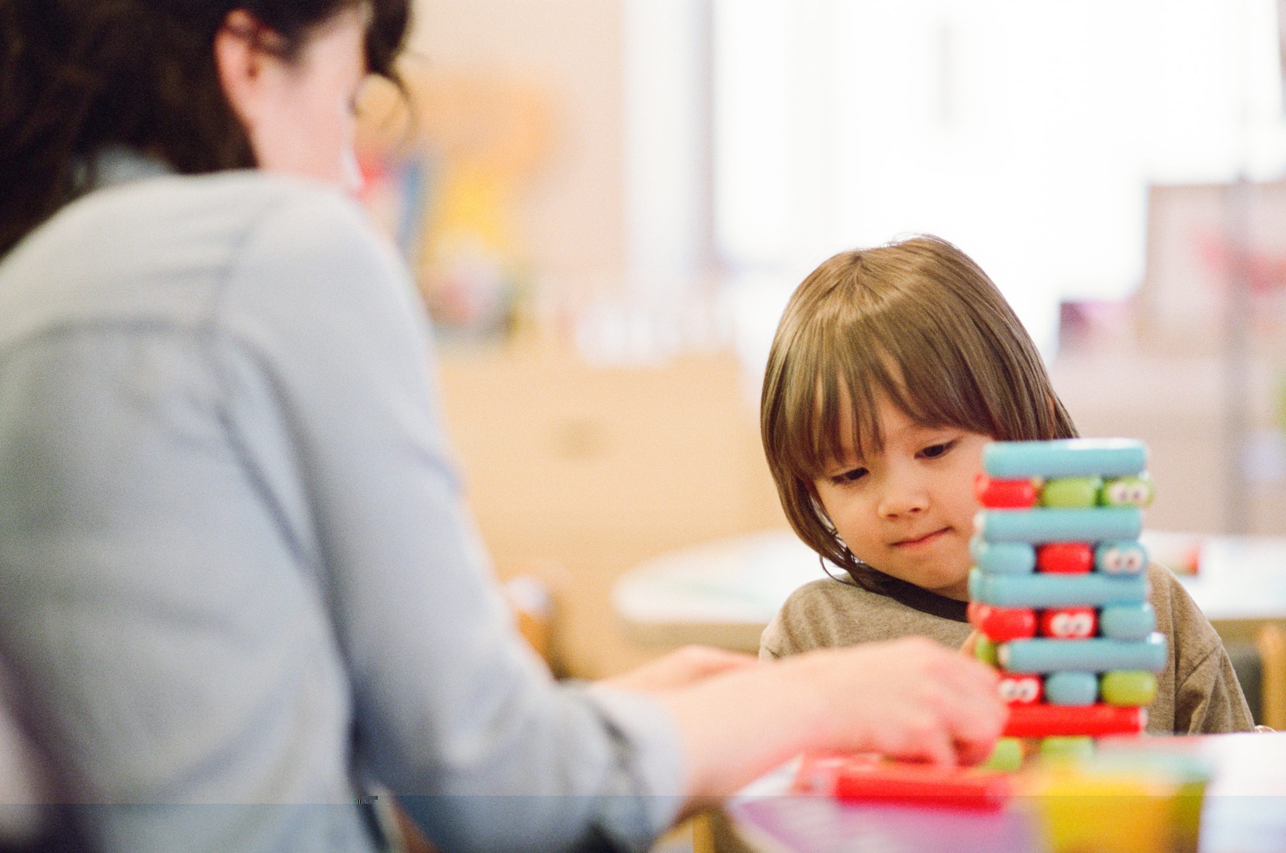 A child plays with a caregiver