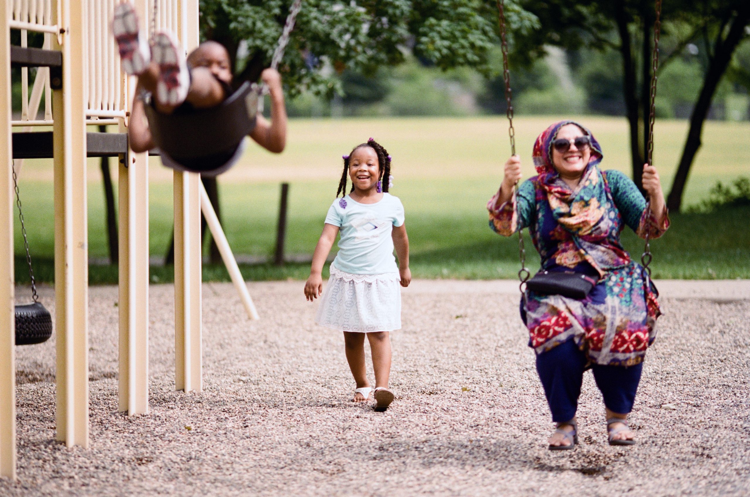 A playmaker on swings with children