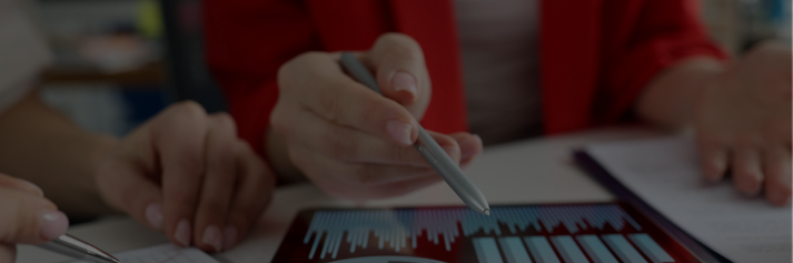 Close-up of a hand pointing to an ipad with a stylus