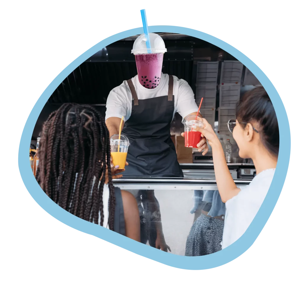 In a playful illustration of a food truck interaction, the operator is depicted with a purple boba tea head, symbolizing a deep connection with the product served. He is extending a red-colored drink to a smiling female customer, while another female with an orange beverage looks on. The vibrant, unique depiction emphasizes the innovative and supportive role that the Table Needs Restaurant Operations Platform plays in enhancing profitability for quick service restaurants, coffee shops, and food trucks.