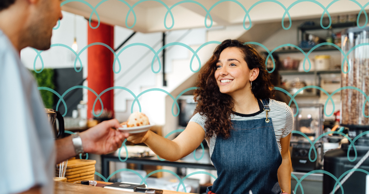 happy cafe owner serving a customer.