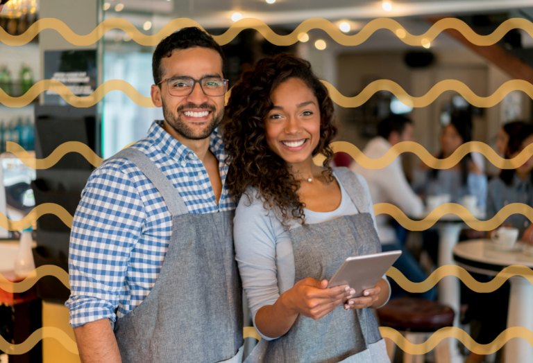 smiling man and woman working in a restaurant