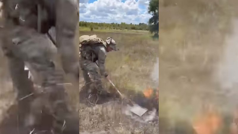 A soldier assigned to the 1st Calvary Division extinguishing a brush fire.