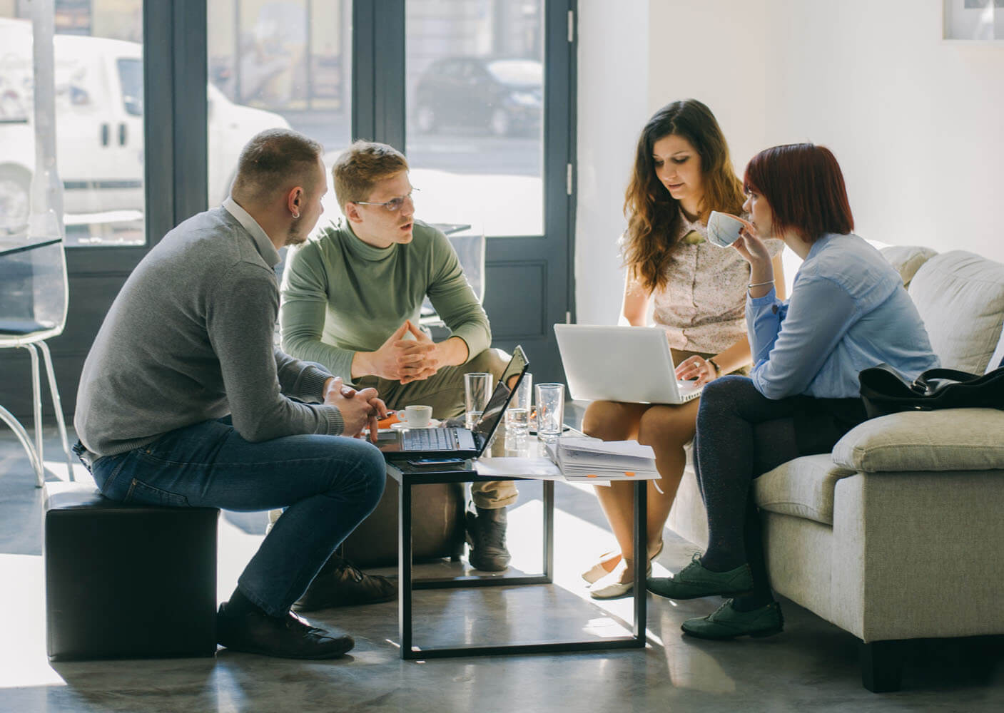 Terakeet Employees Meeting at Table about how owned asset optimization (OAO) helps build stronger customer connections