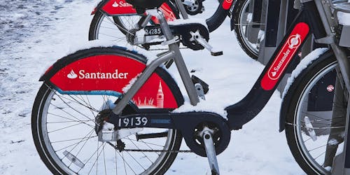 A Santander rental bike in London, surrounded in snow