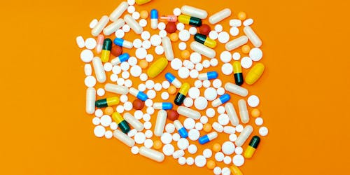 Pills arranged attractively on an orange background