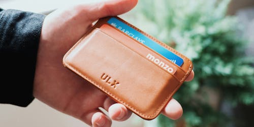 A wallet with two cards in it, one Monzo and one Barclays 