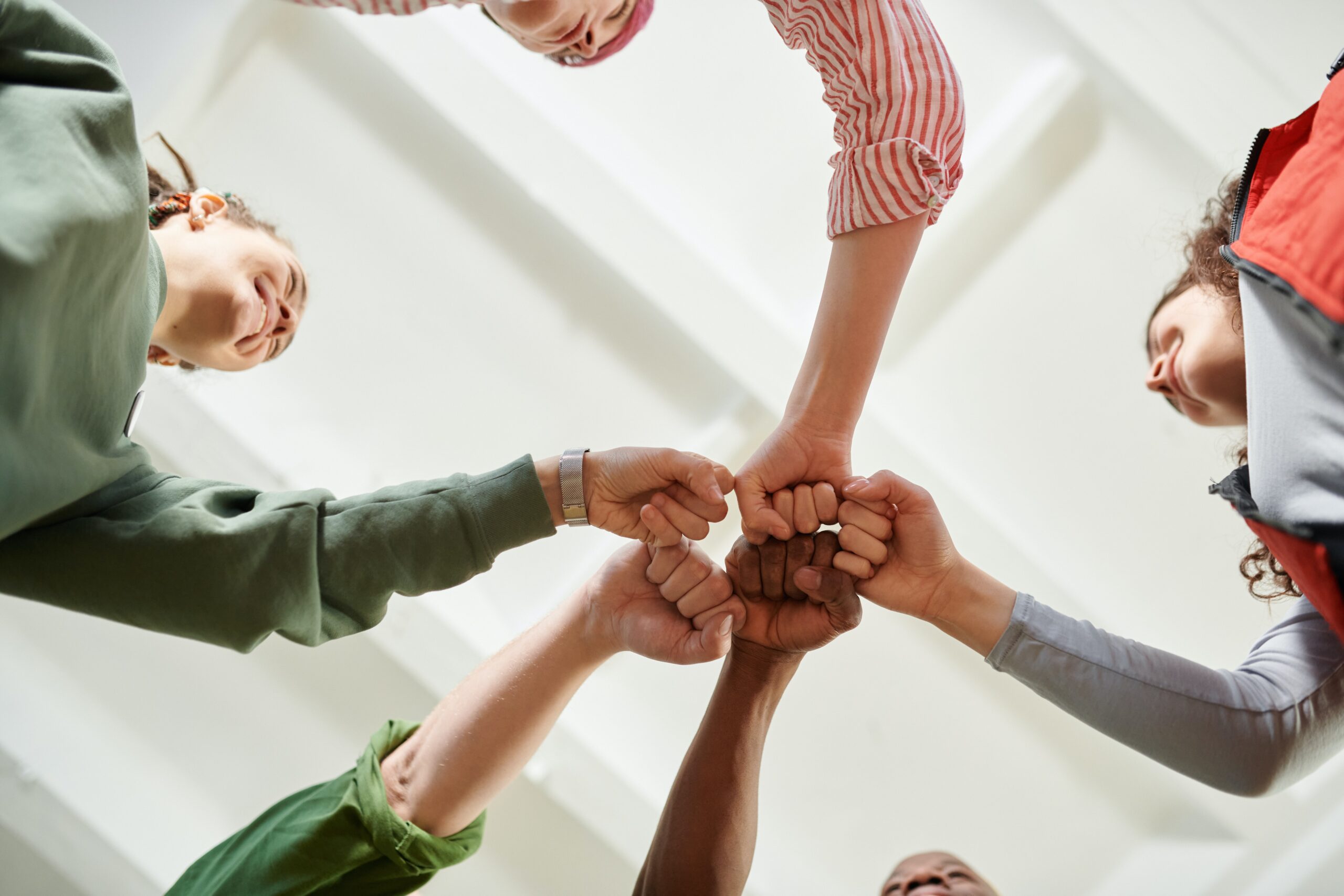 Co-workers bump fists after a successful outcome. Trayak's team works collaboratively with each other and our customers.