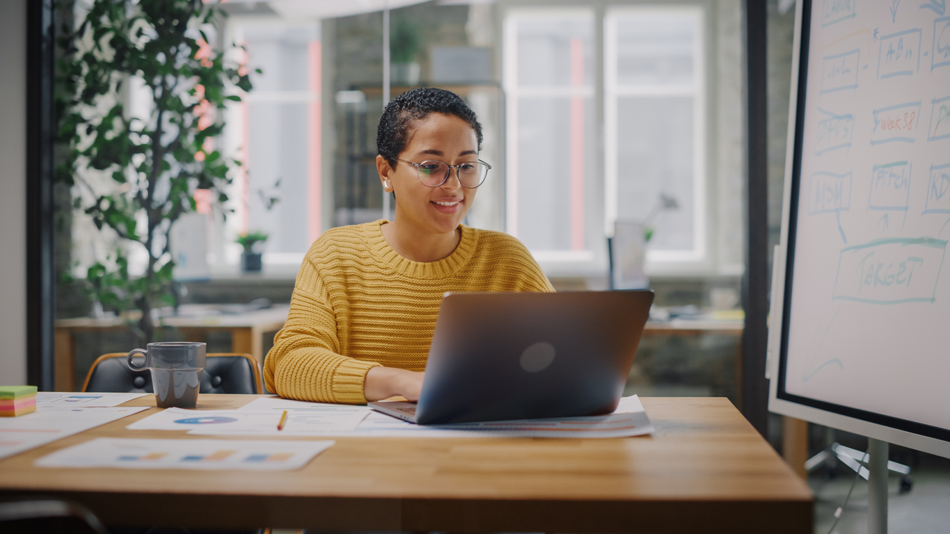 A young professional examines data on her laptop. Trayak's EcoImpact Sustainability Platform streamlines your data collection and reporting process.