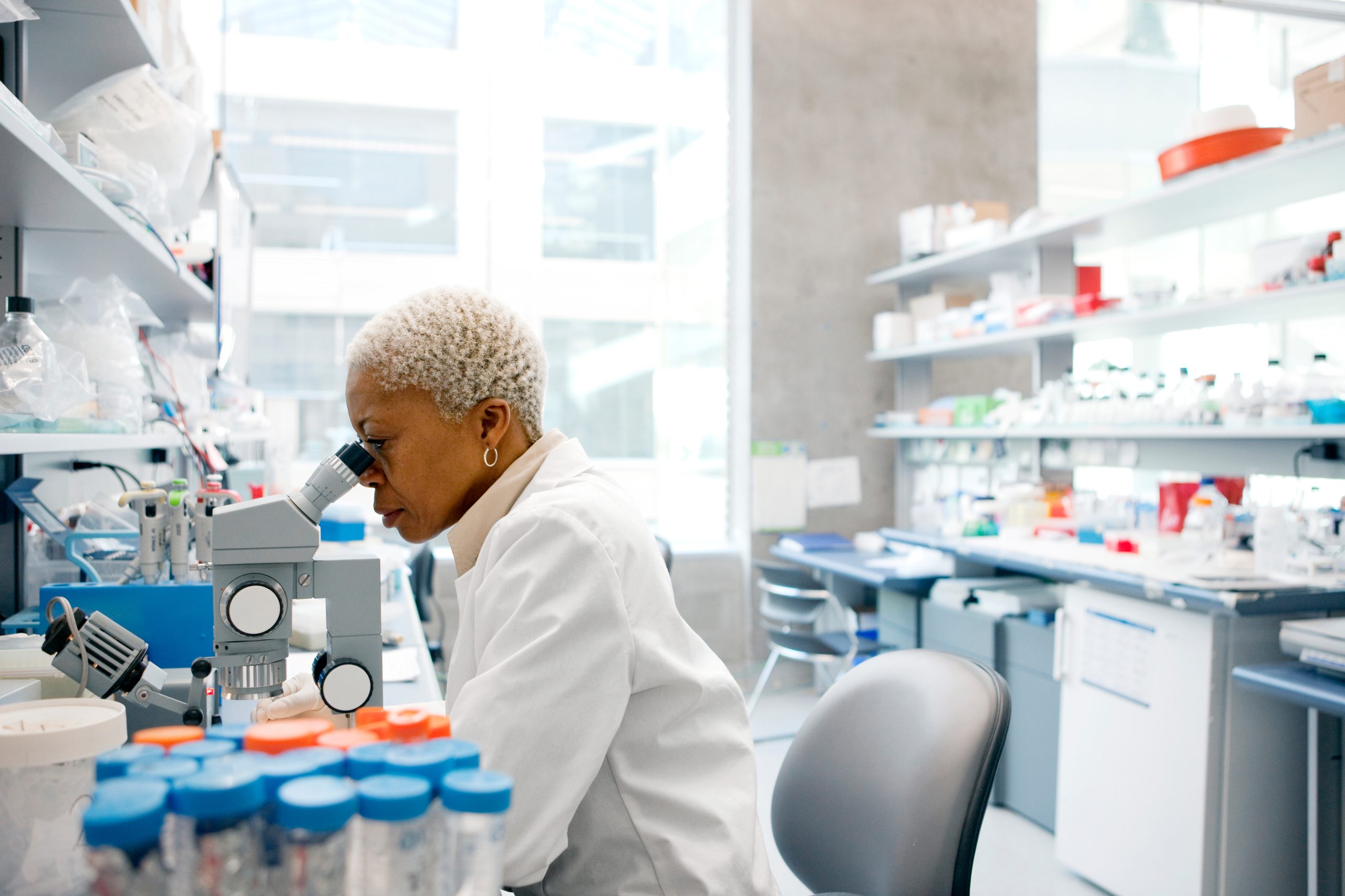 Lab technician using microscope