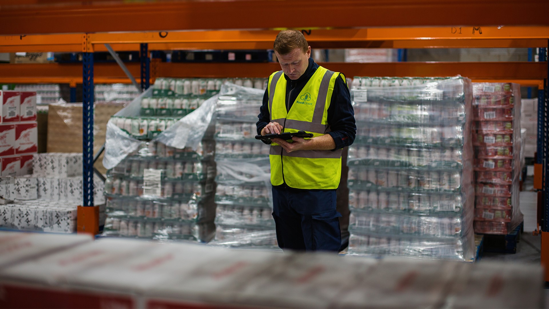 Man in warehouse on device