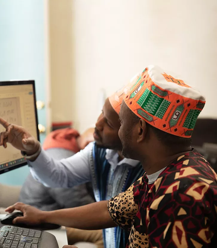 Ibrahima Barry at a computer with eager learner