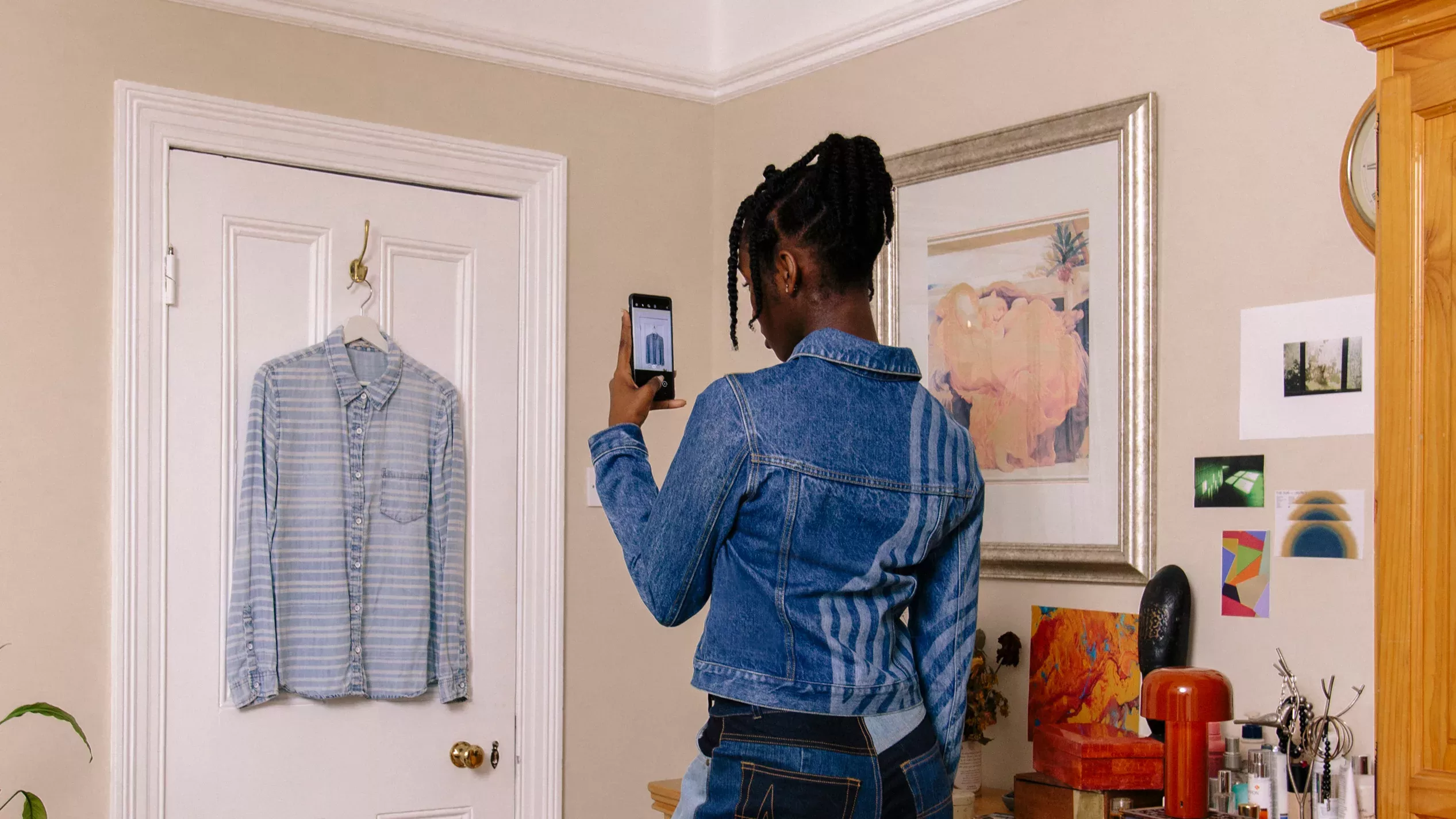 person taking photo in Circulate app of a hanging shirt