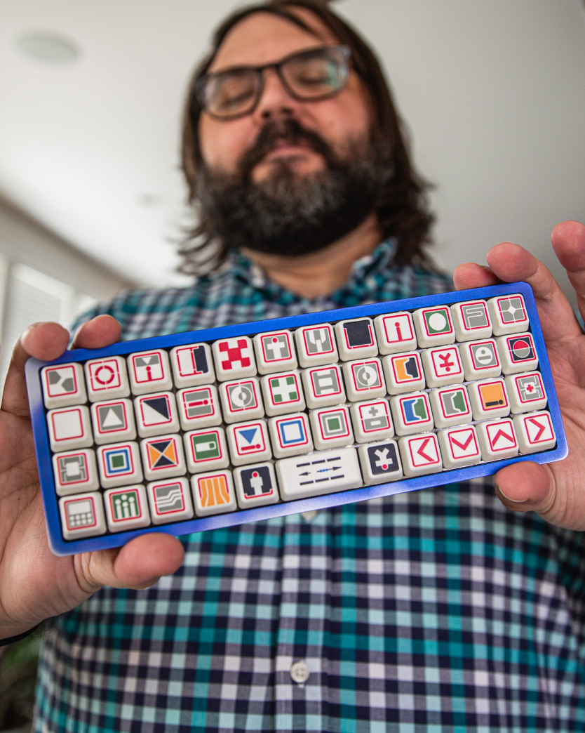 Man holding up custom keyboard.