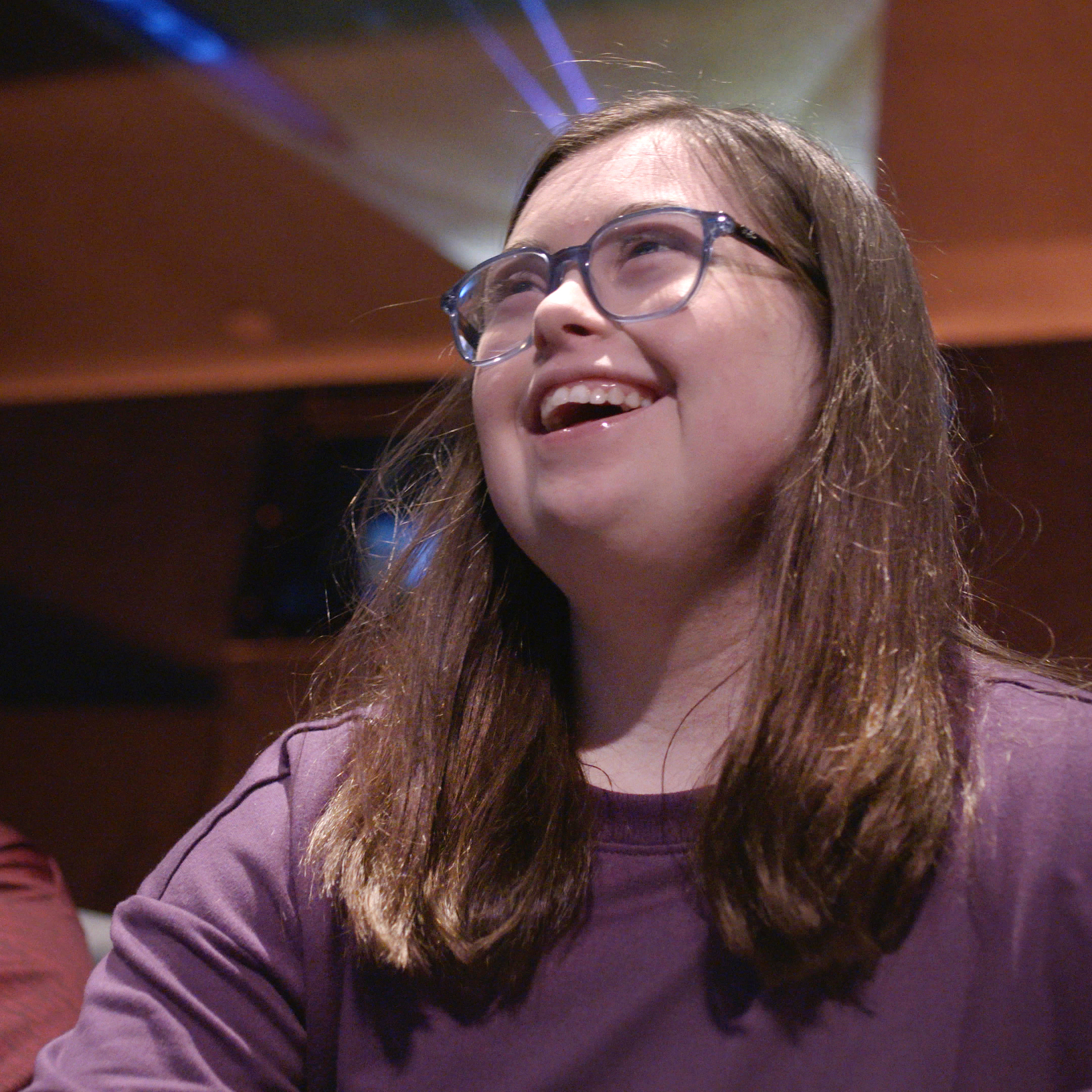 Women in glasses smiling.