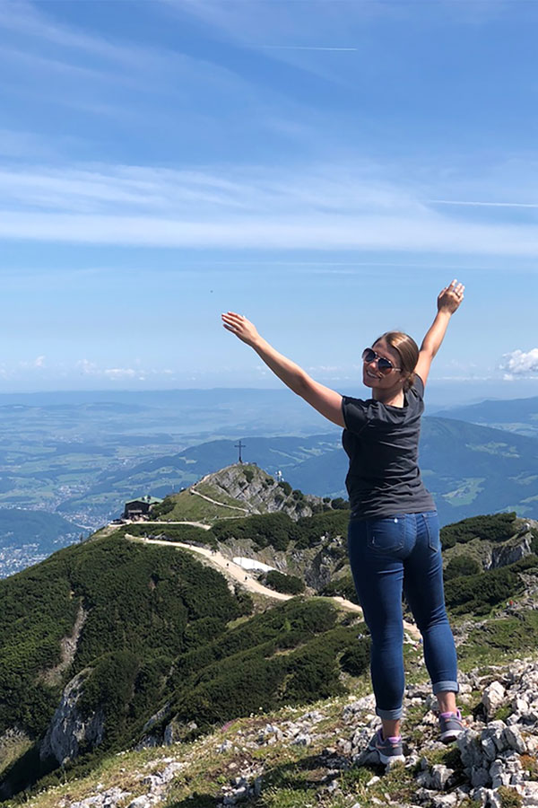 Student on top of a mountain