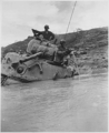 A tank sunk in 5 feet of water waits for towing equipment, Okinawa, 05/1945