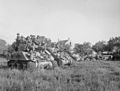 Sherman tanks carrying infantry wait for the order to advance at the start of Operation 'Goodwood', 18 July 1944.