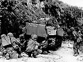 Marines take cover behind one of their medium tanks, Saipan, July 8, 1944.