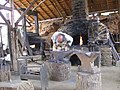 Français : Forgeron à Guédelon English: Blacksmith in medieval site of Guédelon