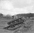 Sherman tank using a Churchill 'Ark' armoured ramp carrier to climb over an escarpment, 13 Feb 1944.