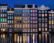 Water reflection of canal houses at blue hour in Damrak Amsterdam the Netherlands.jpg