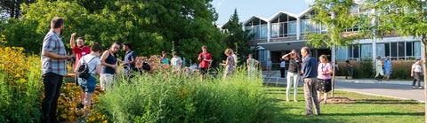 Grebel students and faculty in the pollinator garden, outside the Grebel residence.