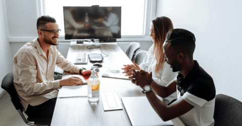 Young professionals sitting at a table conversing