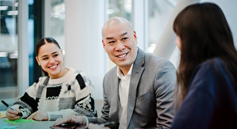 Simon Chan sitting down to talk to two people