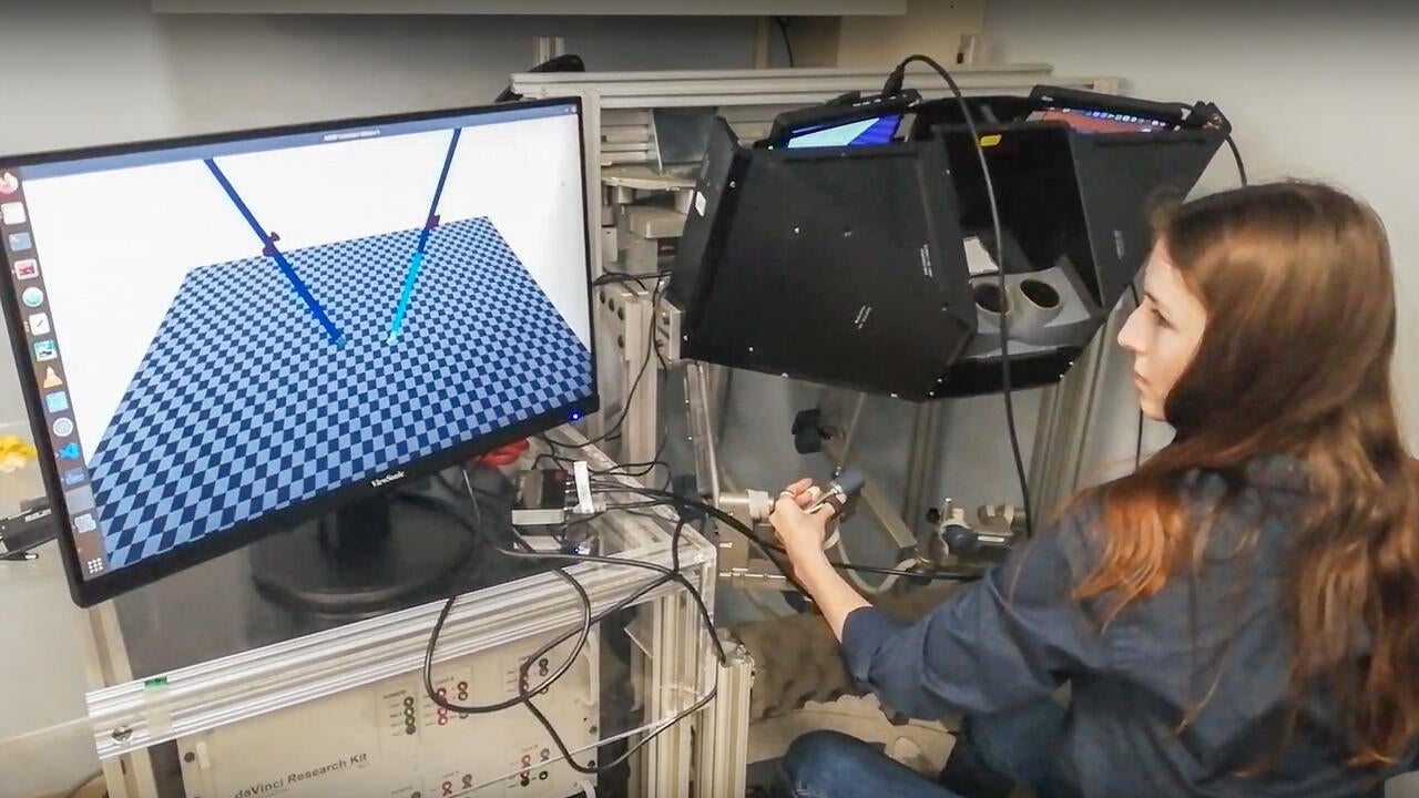 Ella Walsh in a lab at SickKids operating a robotic simulator