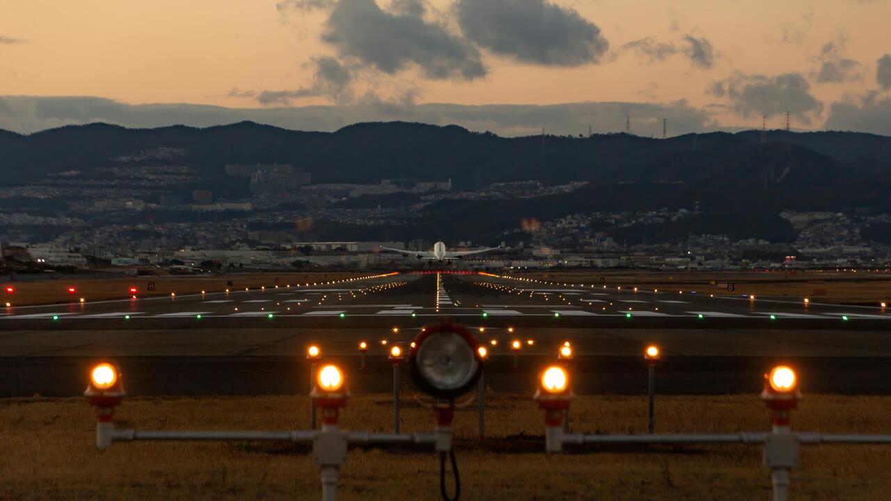 Airplane on the tarmac about to take off during sunset