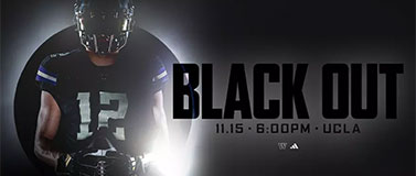 UW football player in black uniform. The words Black Out are written on the right side.