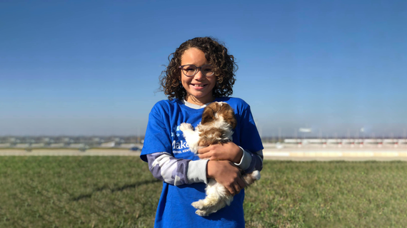 Wish kid Nya holding puppy