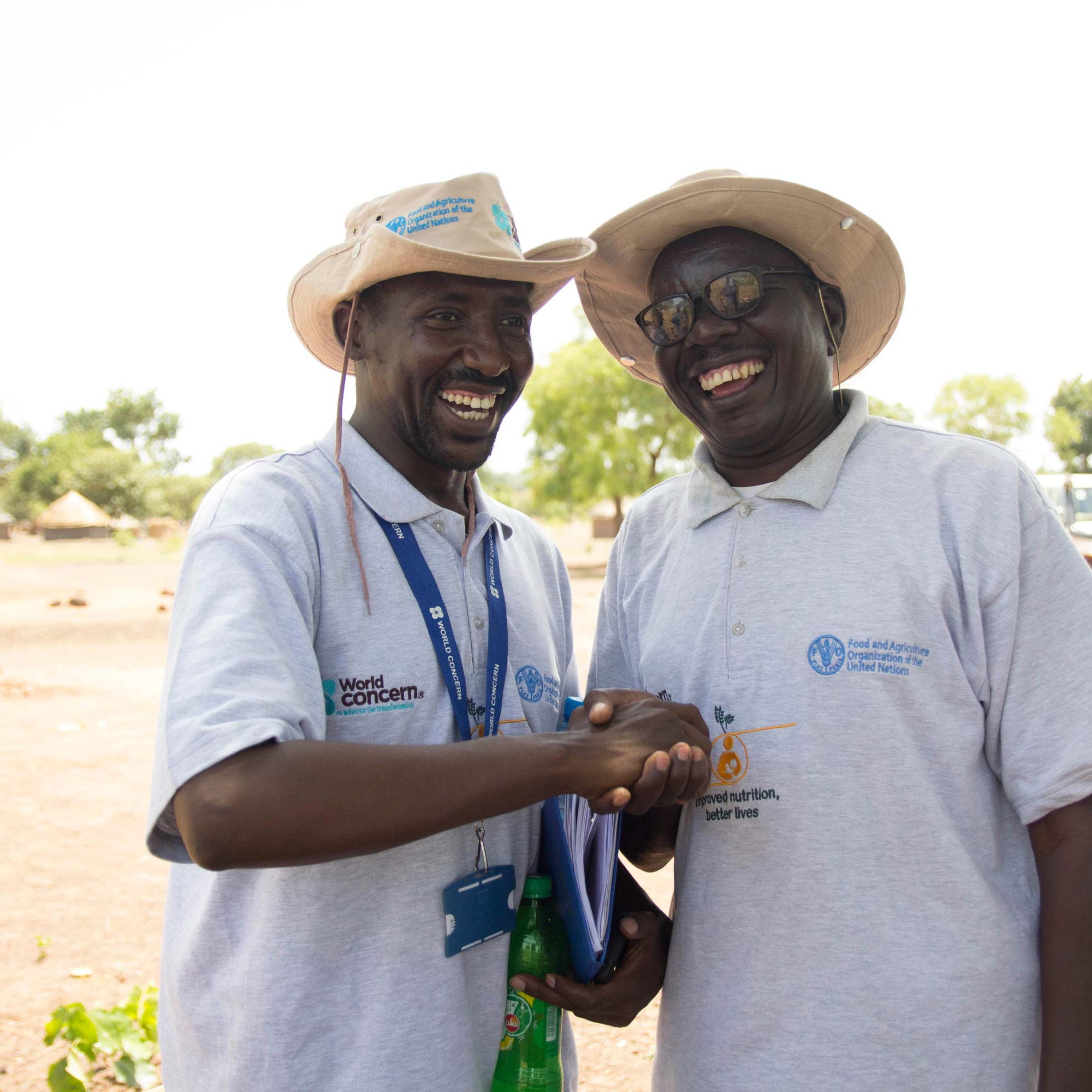 A World Concern staff member shakes hands with a partner