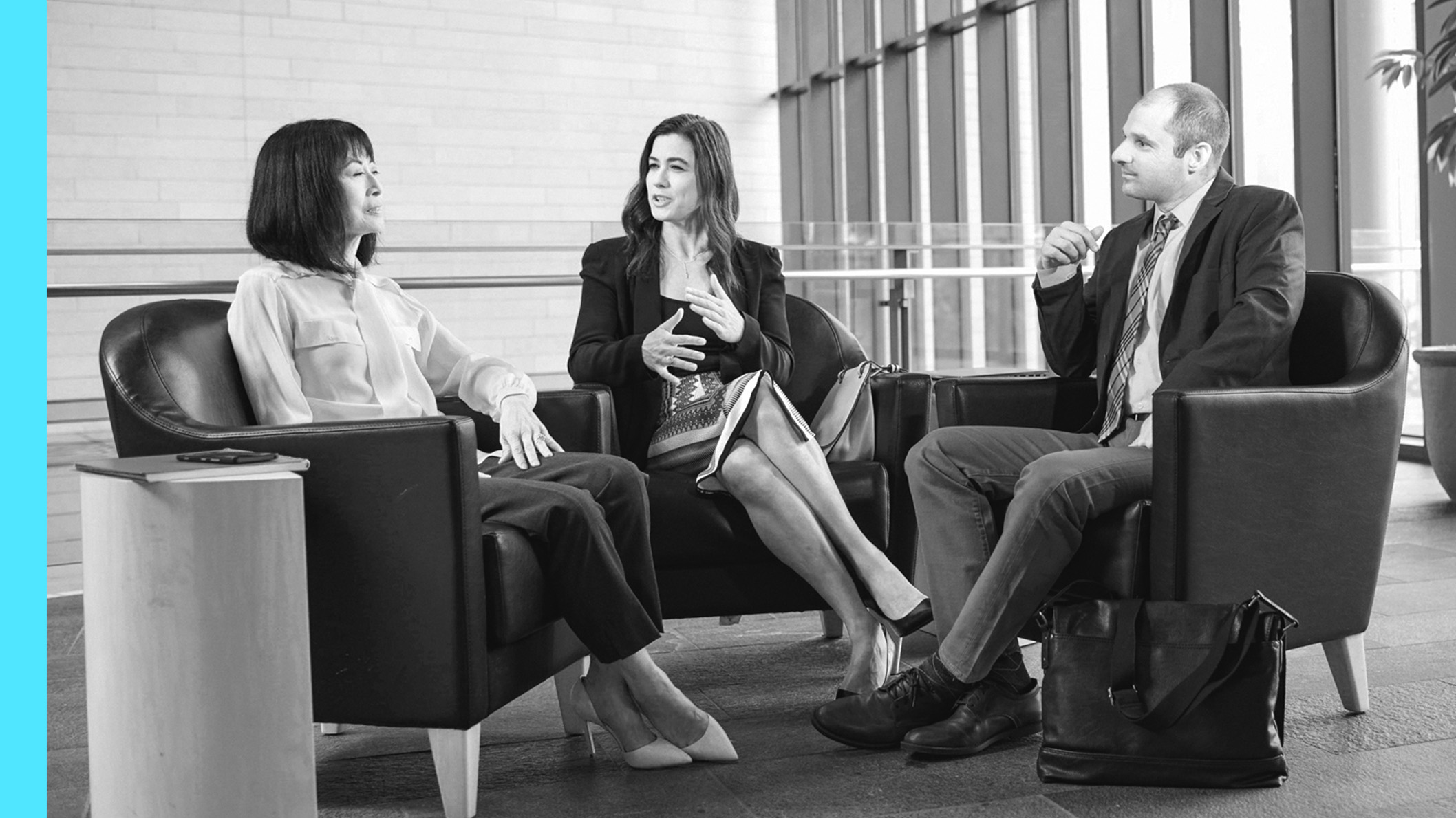 Three people sitting and having a discussion