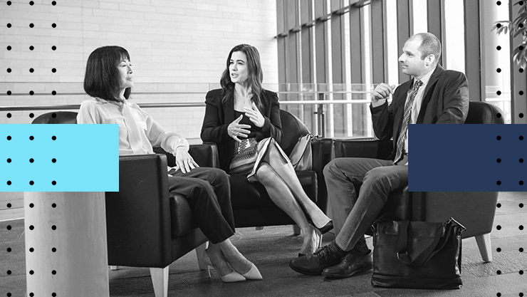 Three people sitting and having a discussion