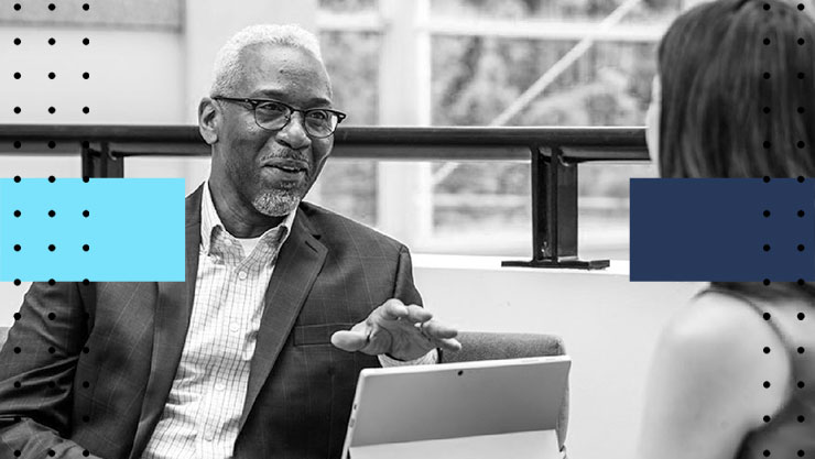 A man having a conversation in front of a laptop