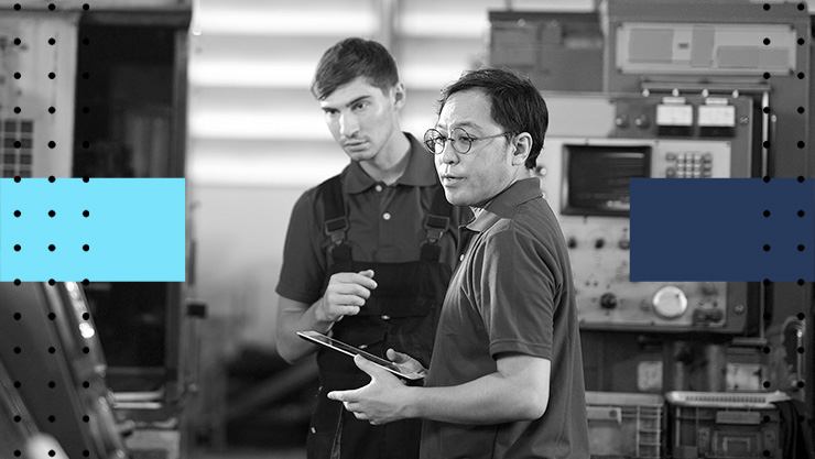 Two people working in a server room