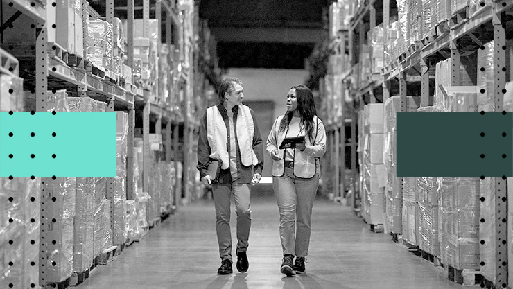 Two people having a conversation in a warehouse