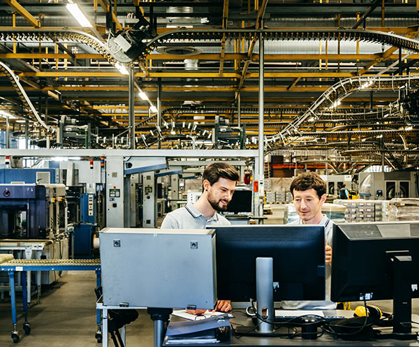 two men looking at a computer monitor