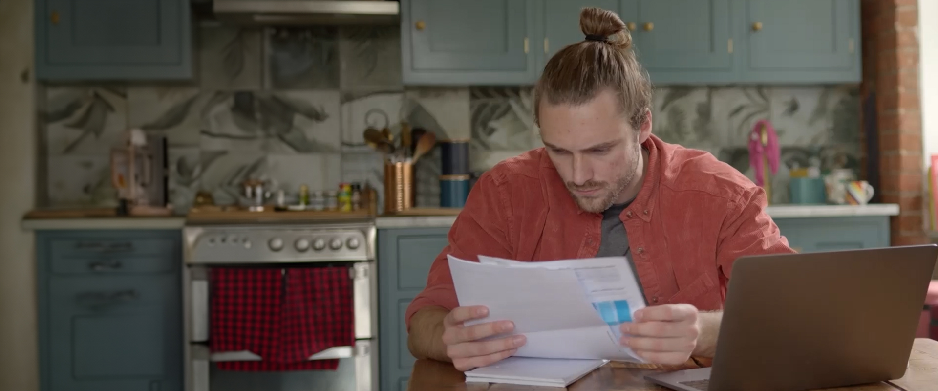 A person working at a table looking at some papers