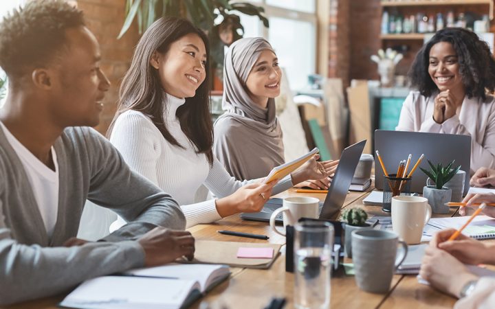 Team of workers smiling in a meeting.