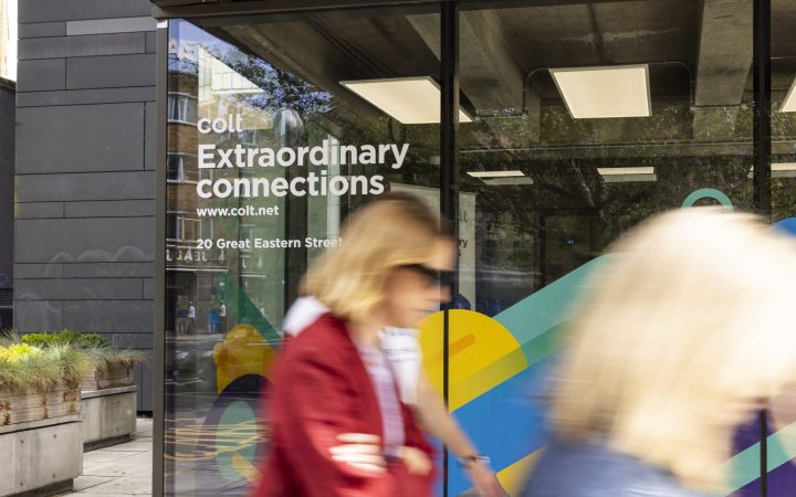 Woman walking past entrance to Colt House