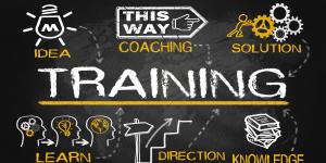 An image of blackboard with the word Training in the middle surrounded by another icon: idea, coaching, solution, learn, direction, knowledge