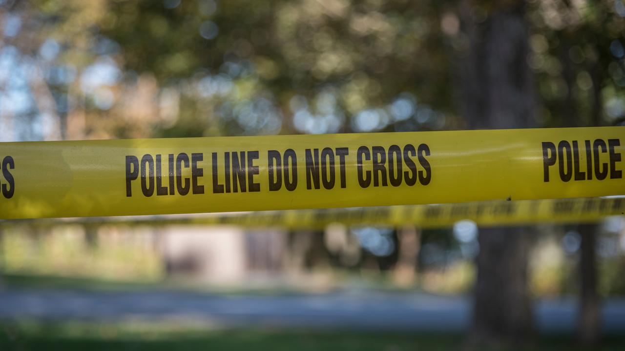 A "DO NOT CROSS" Police banner located at a crime scene