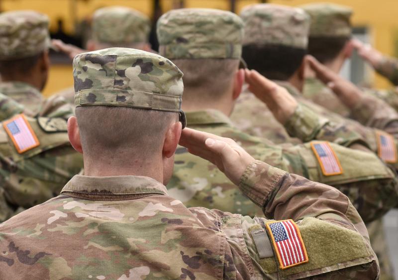 Soldiers saluting from behind