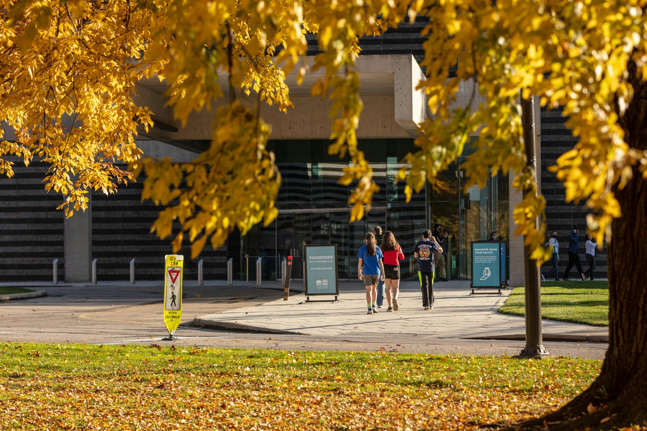 Visitors entering the museum on a beautiful fall day