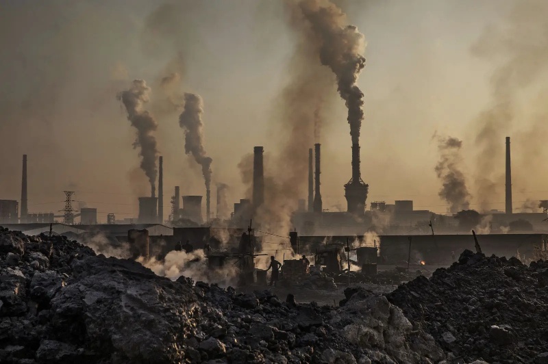 Smoke billows from a towering smokestack at a steel plant in Inner Mongolia, contributing to air pollution