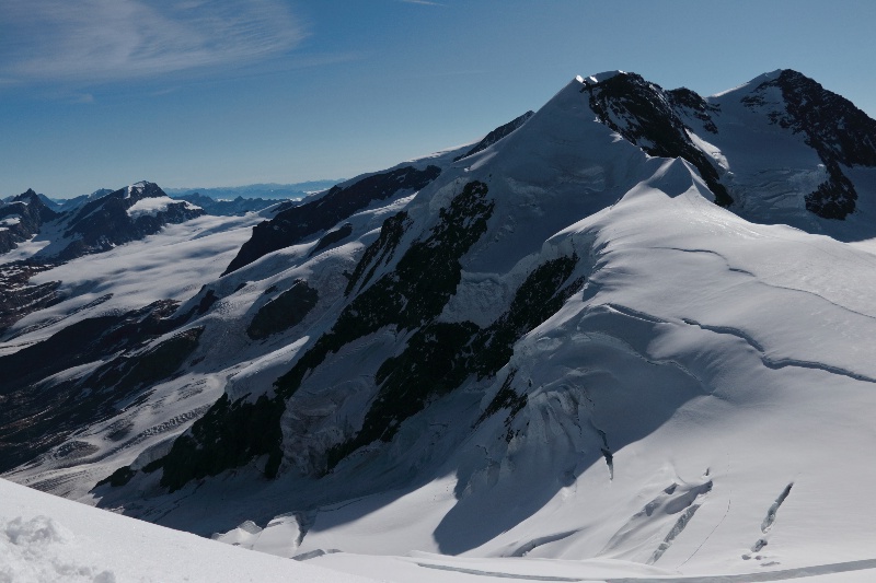 View of glaciers from Mt. Castore, 4228 m, in the Mount Rosa massif, Alps, showcasing icy peaks and rugged terrain