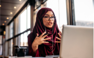 woman speaking in online meeting via laptop